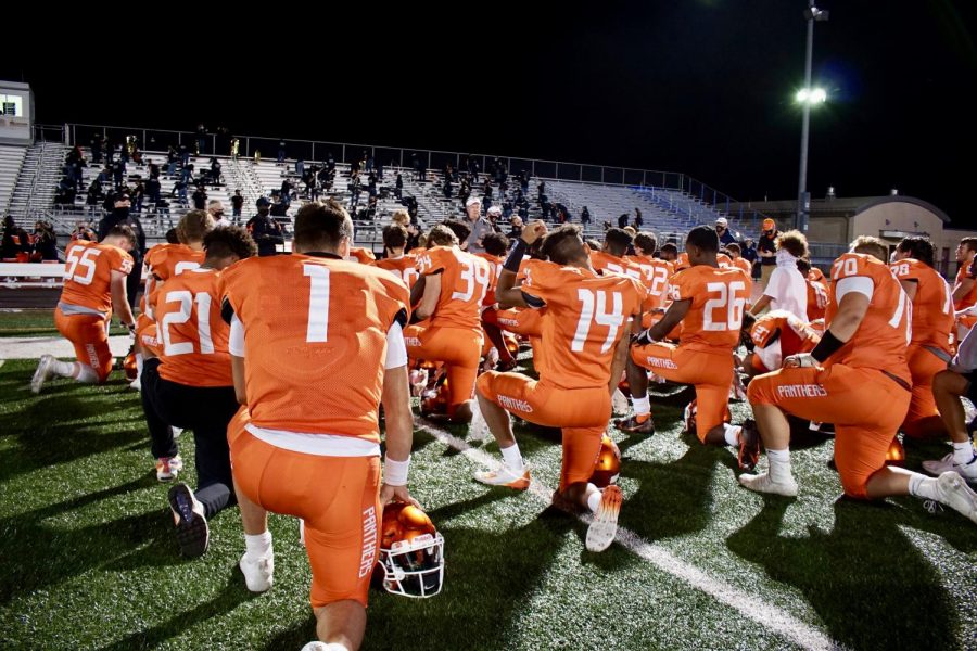 Central York High Schools football team kneels as the national anthem plays during their game against Red Lion.
Photo by Ean Mealey 