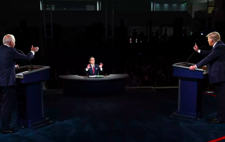 Joe Biden (left) and Donald Trump (right) debate at Case Western University in Cleveland, Ohio, while Fox’s Chris Wallace (middle) struggles to moderate. Photo by Associated Press. 
