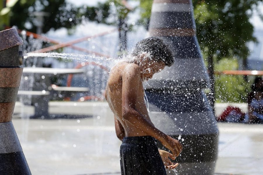 A boy cools off at Yesler Spray Park in Seattle during a record-setting heat wave in June. 