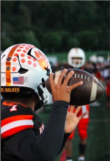 Cerminara’s photography captures small and potentially unnoticed moments like the football team adding remembrance stickers to the helmets of a late high school teacher and mentor, Ms. Erin Walker. “This has to be my favorite so far. It just looks visually appealing; everything is centered, and I thought it was really cool,” said Cerminara. 