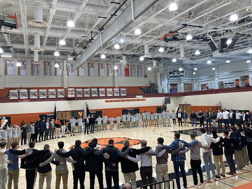 Current and former players gathering together in a circle during coach Goodlings ‘Celebration of Life’ ceremony Feb. 5, 2023. 