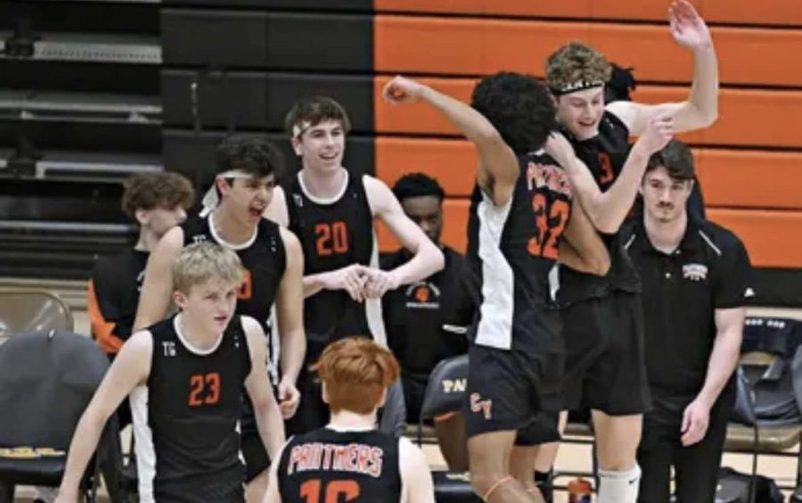 Devon Marsh and sophomore Lance Shaffer go up for a shoulder bump after forcing the opposing team to call a timeout, while the rest of the team celebrates. 