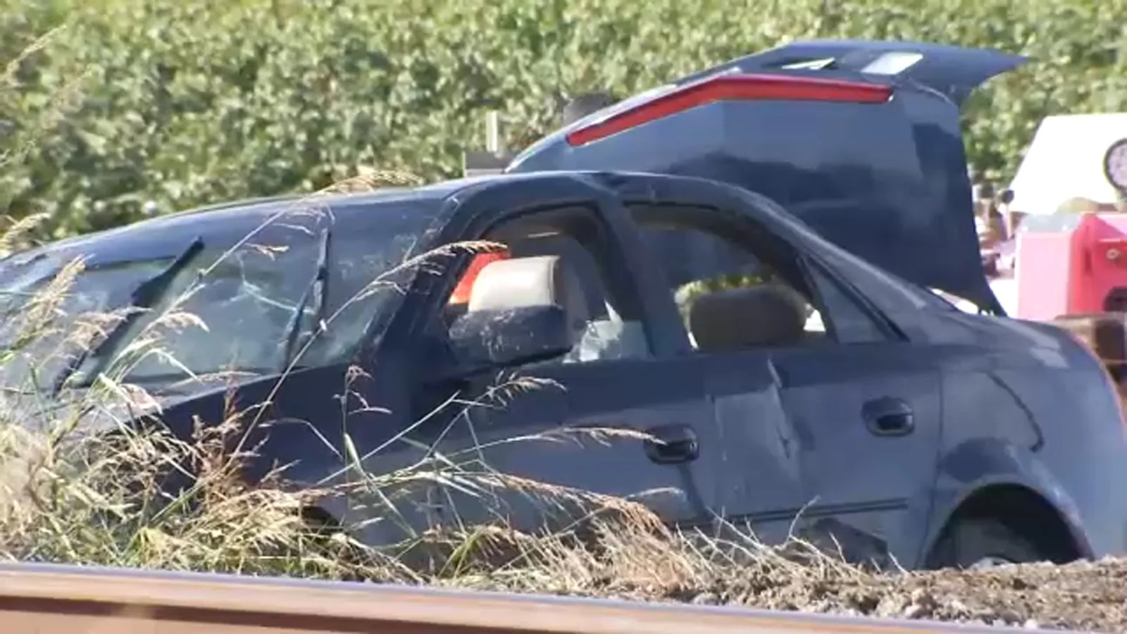 Police and emergency crews responding near an overturned SUV in a canal