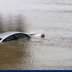 Floodwater covers roads and neighborhoods after heavy rain from Tropical Storm Edouard remnants