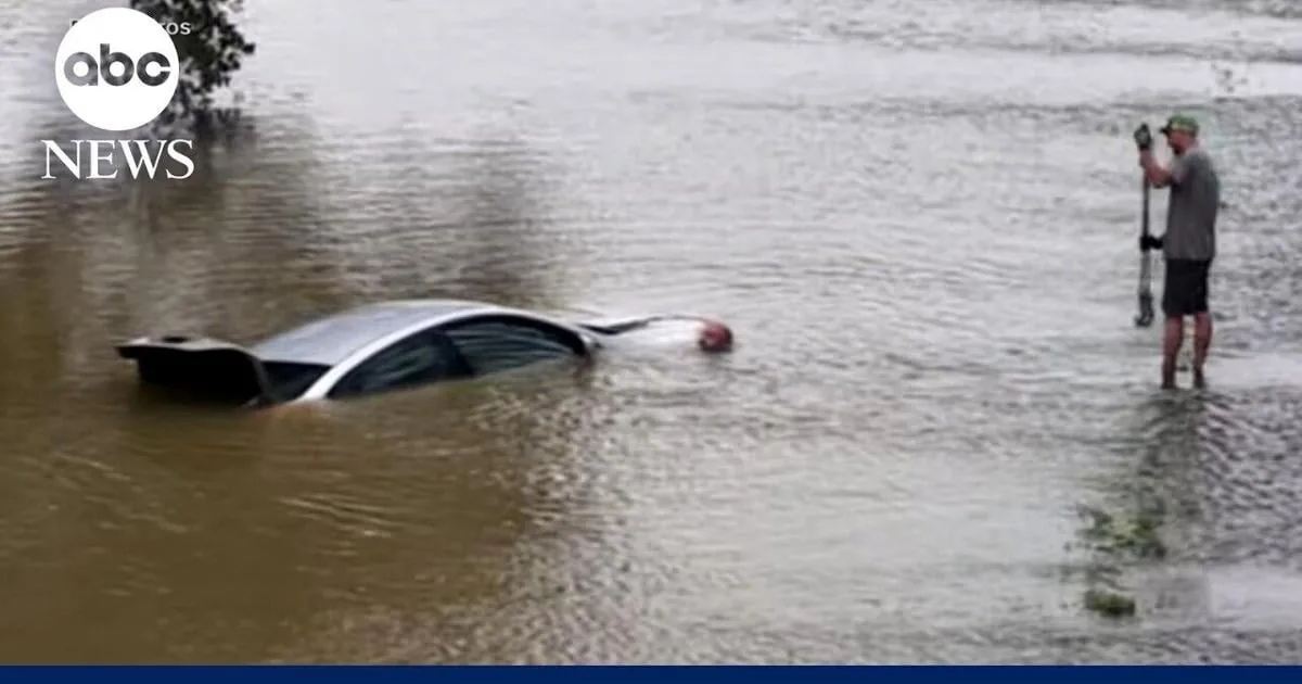 Floodwater covers roads and neighborhoods after heavy rain from Tropical Storm Edouard remnants