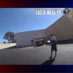 Costa Mesa police vehicle outside a Harbor Boulevard store during a theft and stolen-car arrest